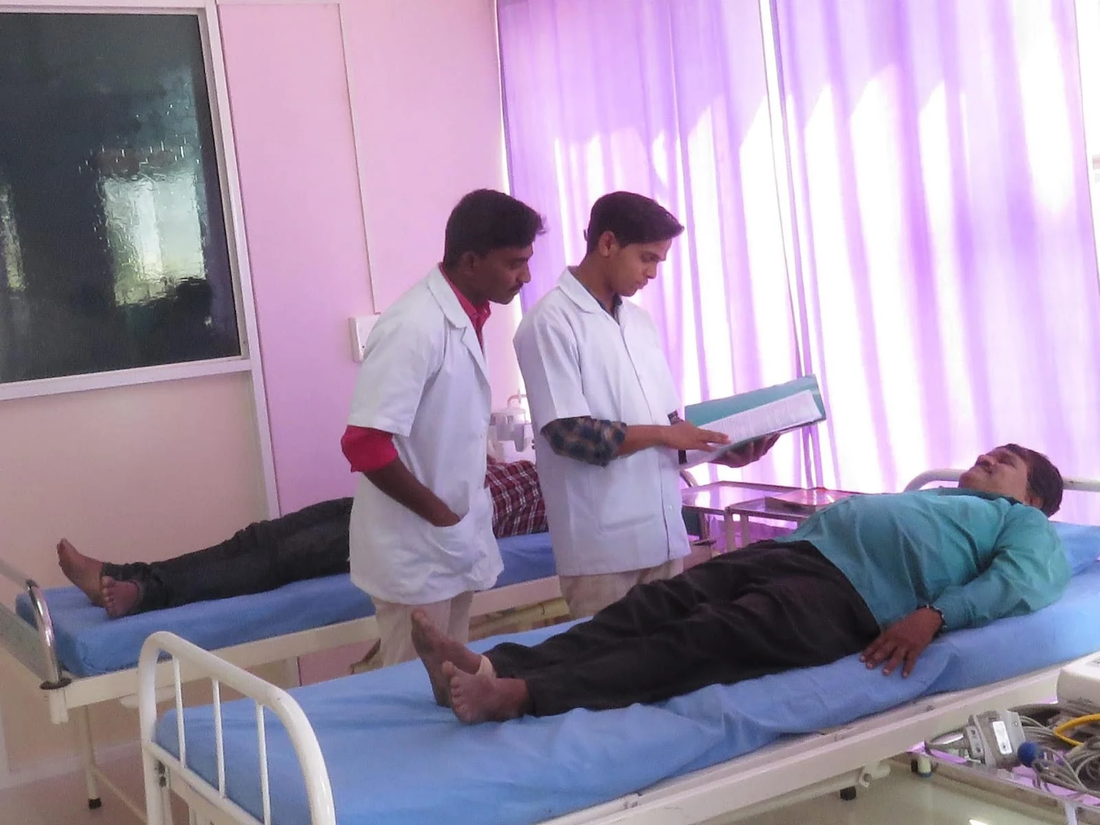 Care workers reviewing a patient file at Jeevan Jyoti in Manjari, Pune