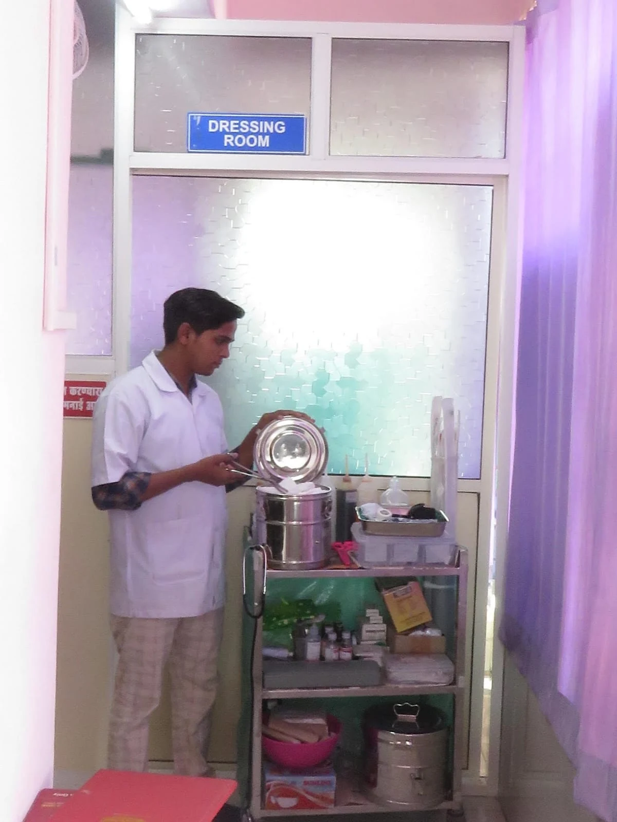A staff member beside the care supply trolley
