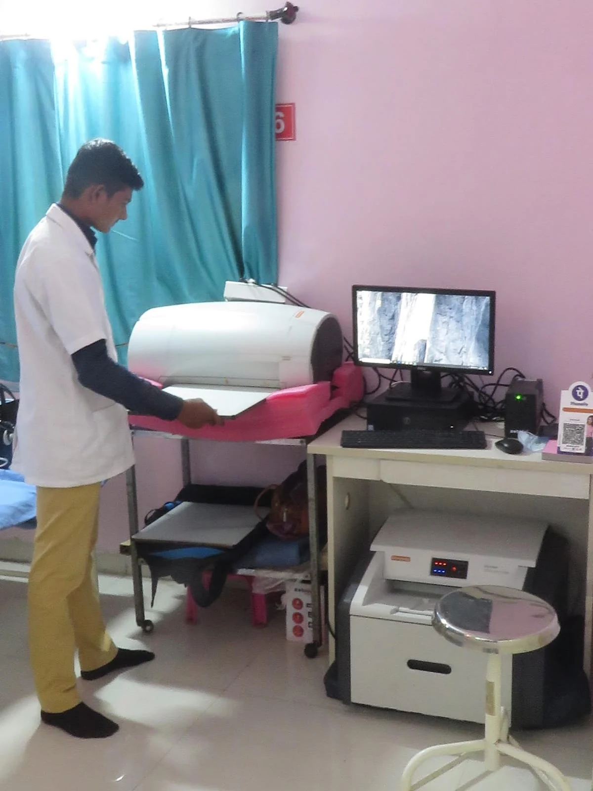 A staff member with equipment in a patient-care area