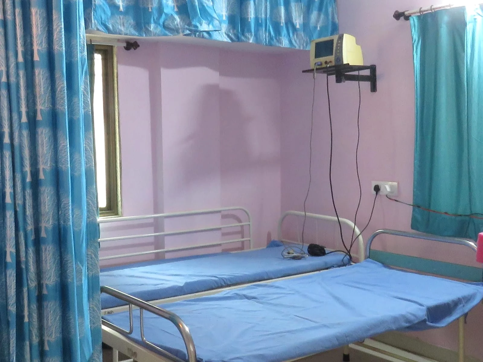 Patient care beds and a wall-mounted monitor inside Jeevan Jyoti