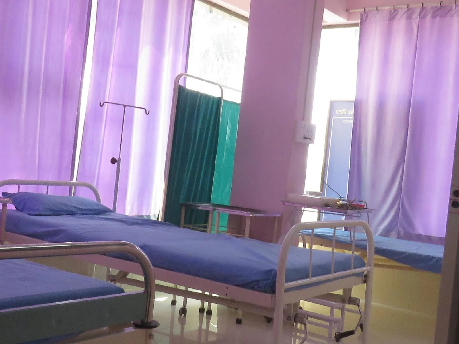 Unoccupied care beds and privacy curtains at Jeevan Jyoti