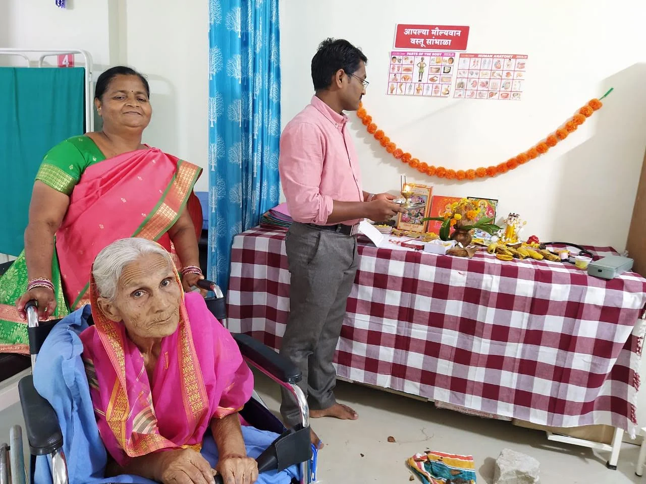 An older woman and visitors during a gathering at Jeevan Jyoti