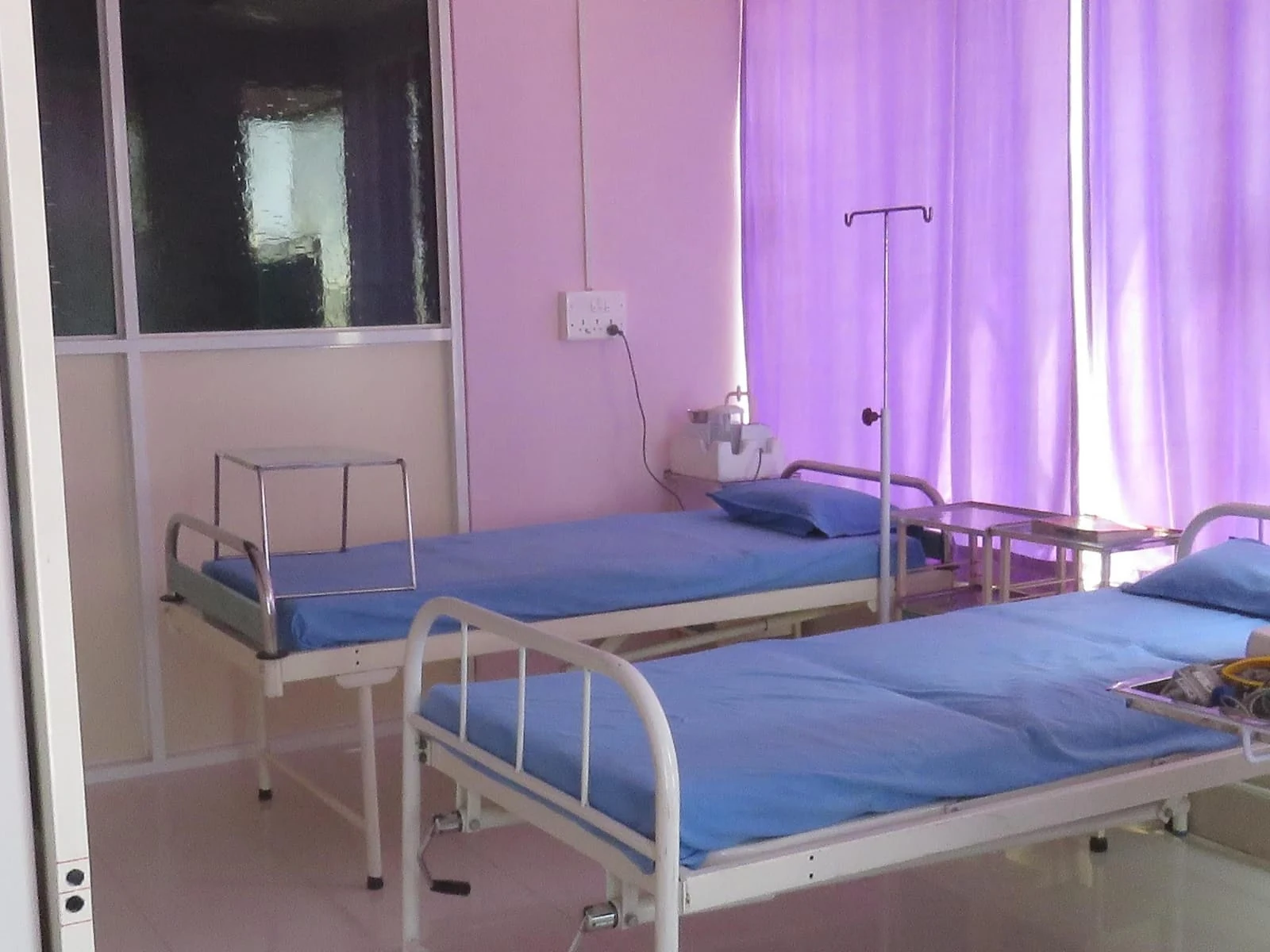 Care beds and privacy curtains in a ward at Jeevan Jyoti